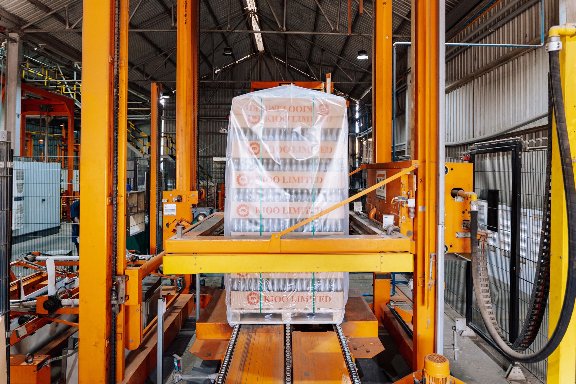 Conveyor belts and package sorting machinery inside an e-commerce distribution warehouse.
