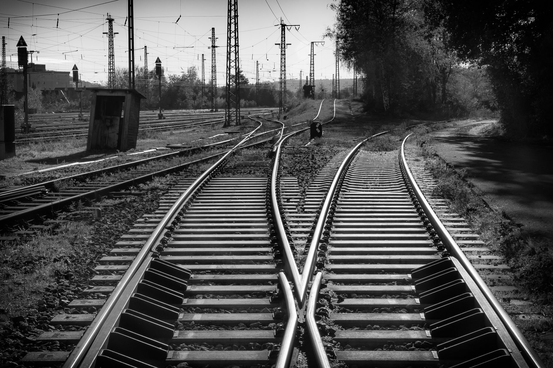 Close-up of a steel railroad switch track splitting into separate directions.