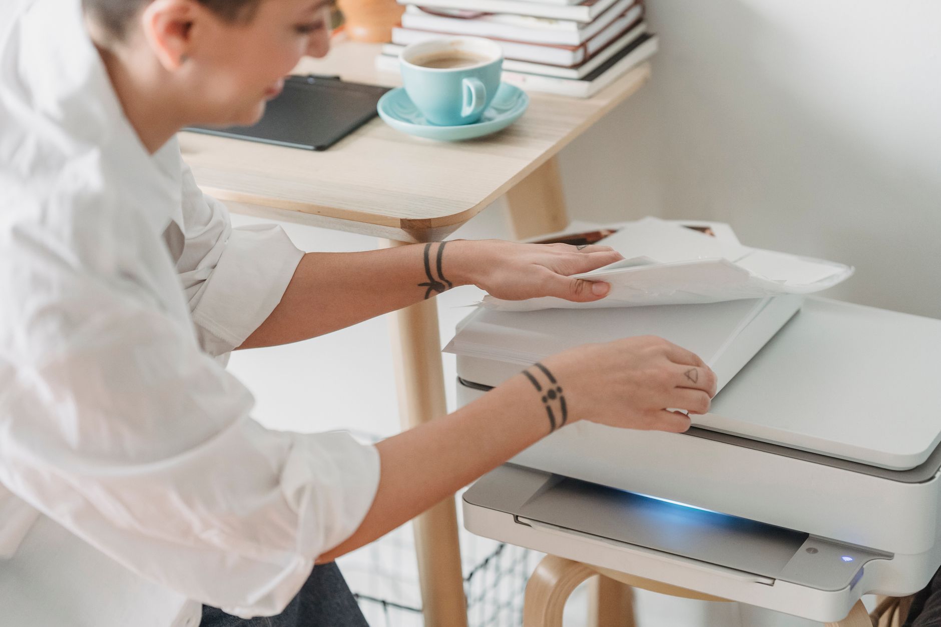 Desktop scanner beside printed PDF pages